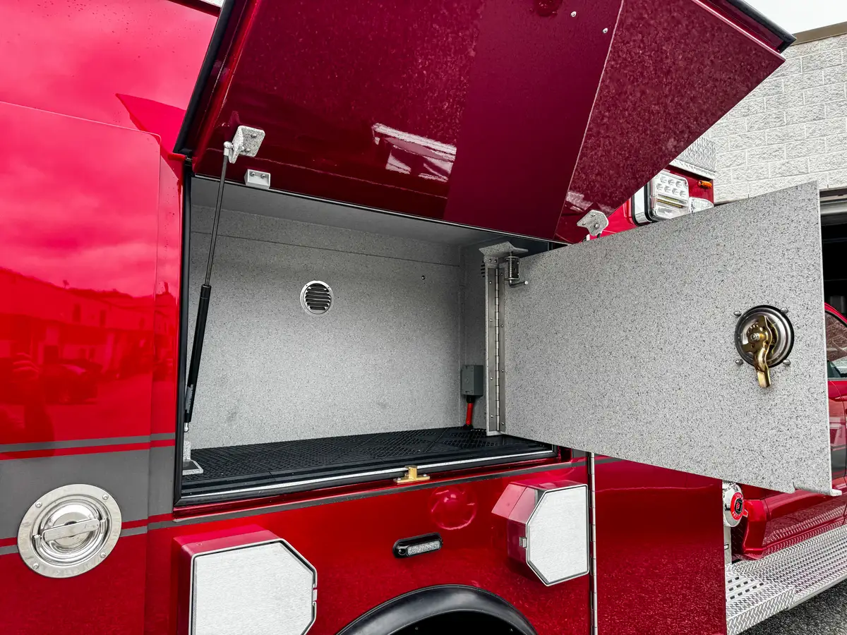 Compartment interior close-up with wiring conduit and side-wall track.